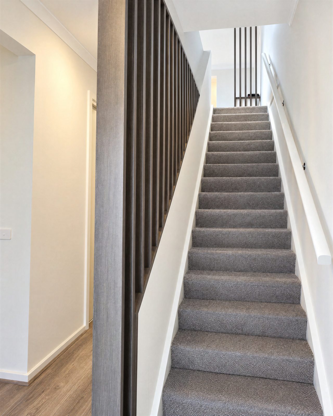 Dark timber batten screen beside a staircase