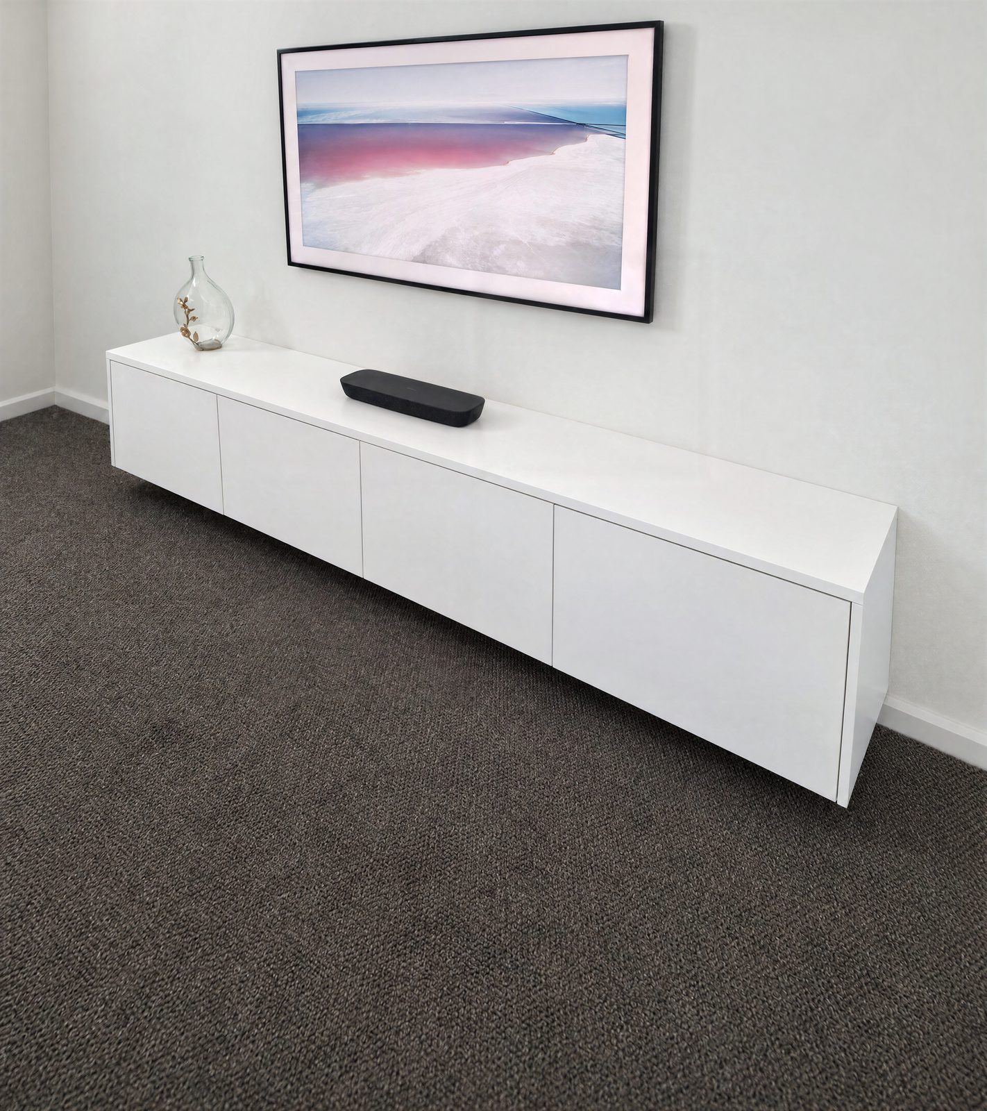 Wall-hung white entertainment unit with handle-free doors